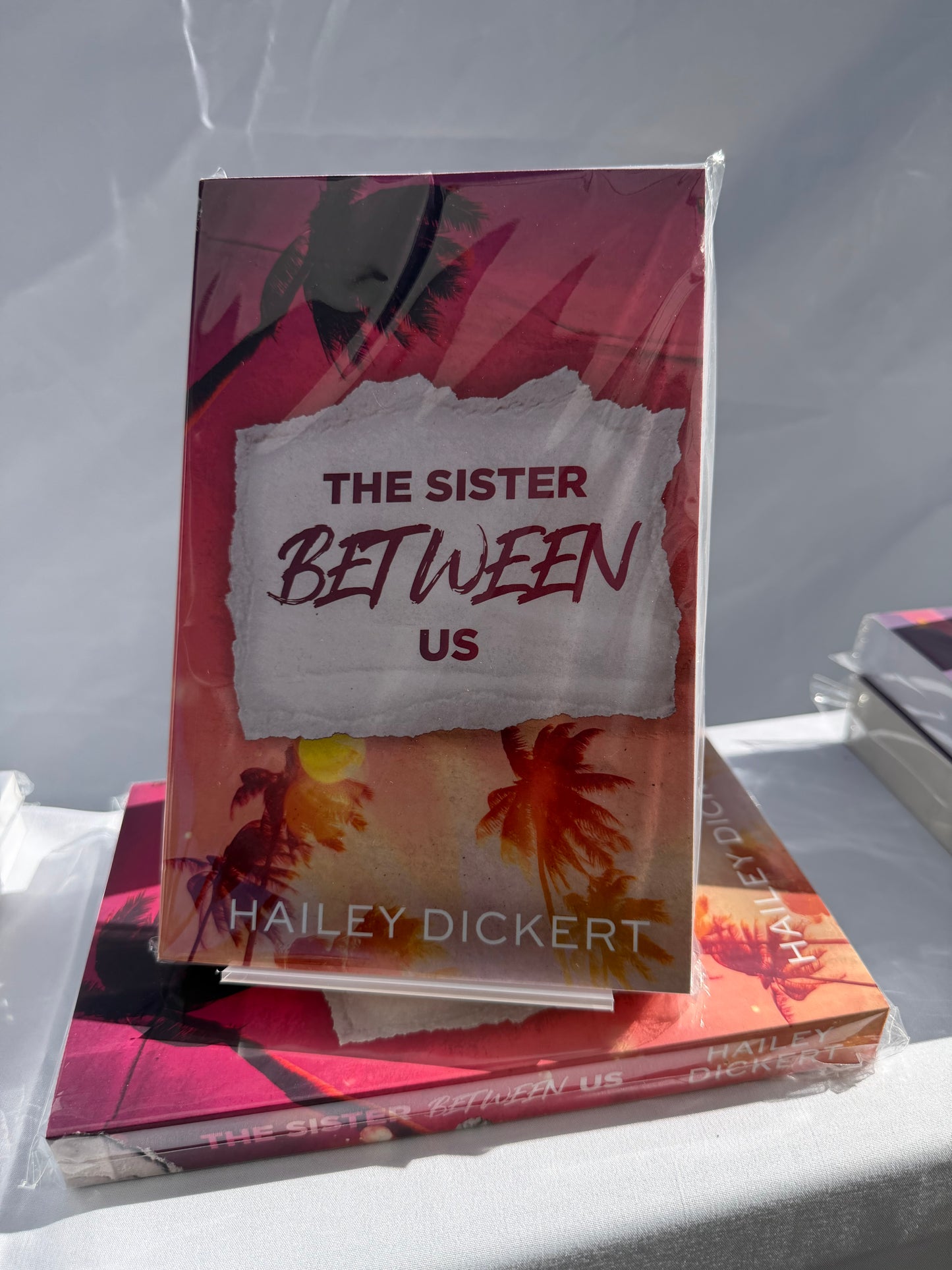 The Sister Between Us by Hailey Dickert